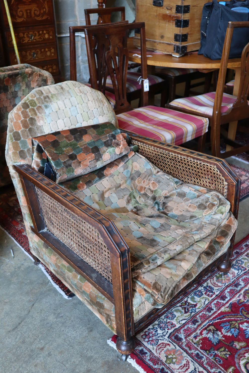 A pair of early 20th century oak bergere armchairs